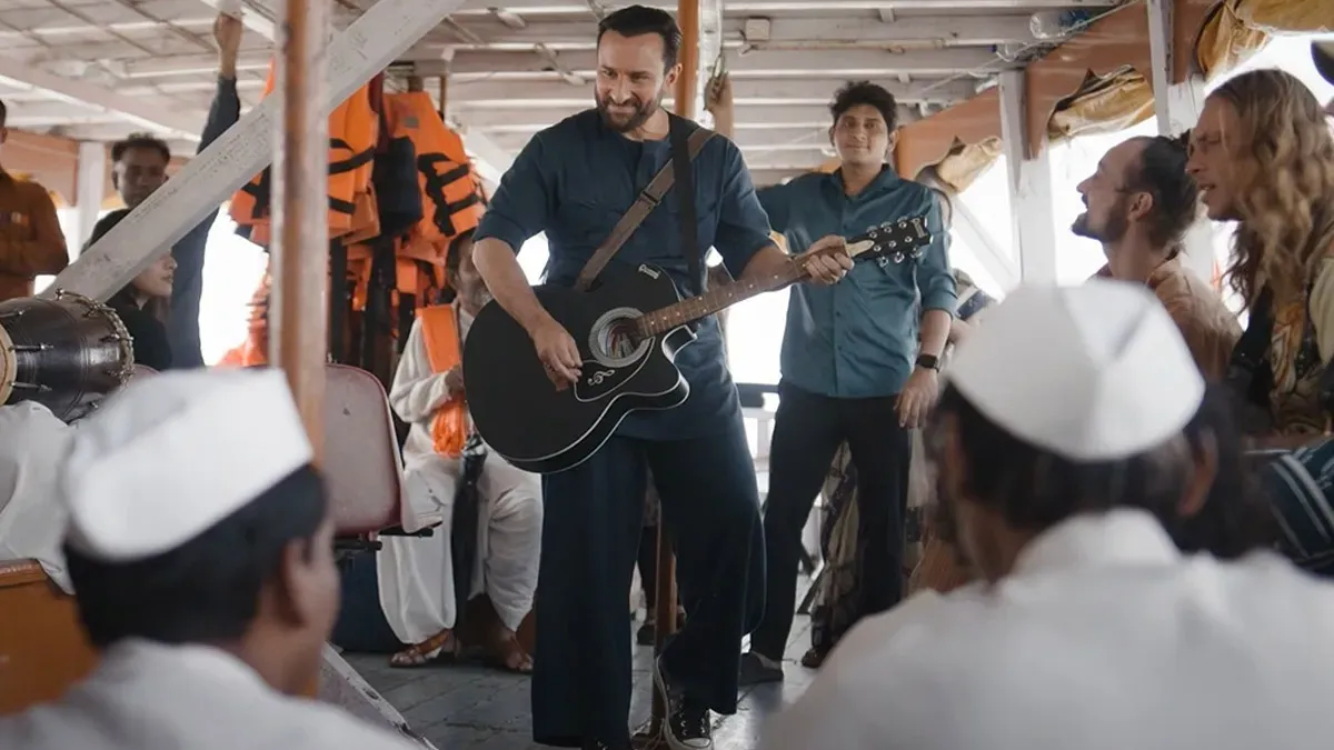 Saif Ali Khan playing a guitar on screen, looking cool and musical.