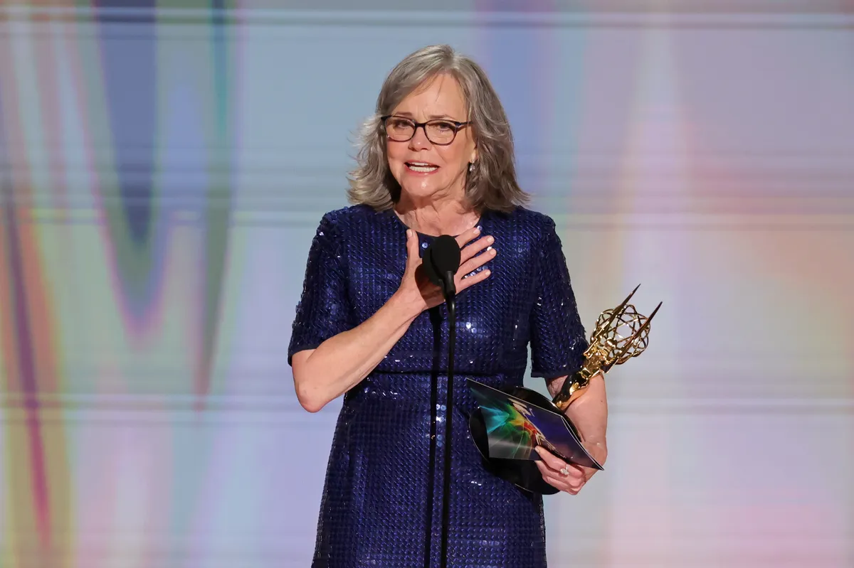 Sally Field accepting an award on stage at the Emmys.