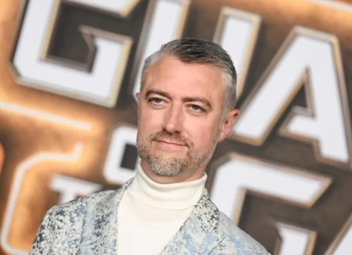 Sean Gunn in a gray motion capture suit, looking like he's acting out Rocket Raccoon.