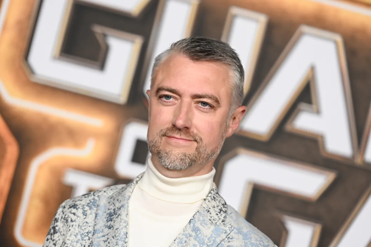Sean Gunn in a gray motion capture suit, looking like he's acting out Rocket Raccoon.