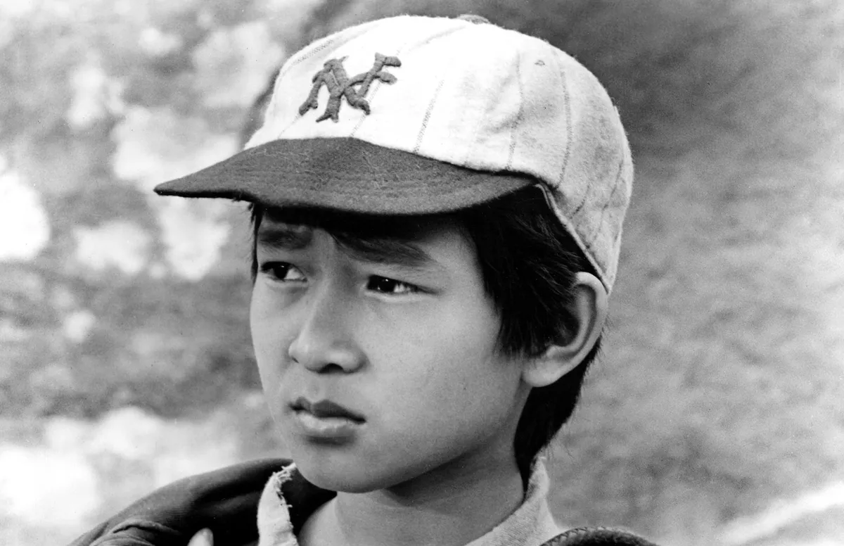 Ke Huy Quan as a child actor on a movie set.