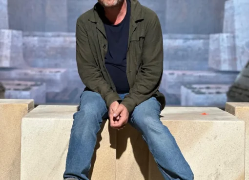 Production designer Patrice Vermette looking at a film set design model.