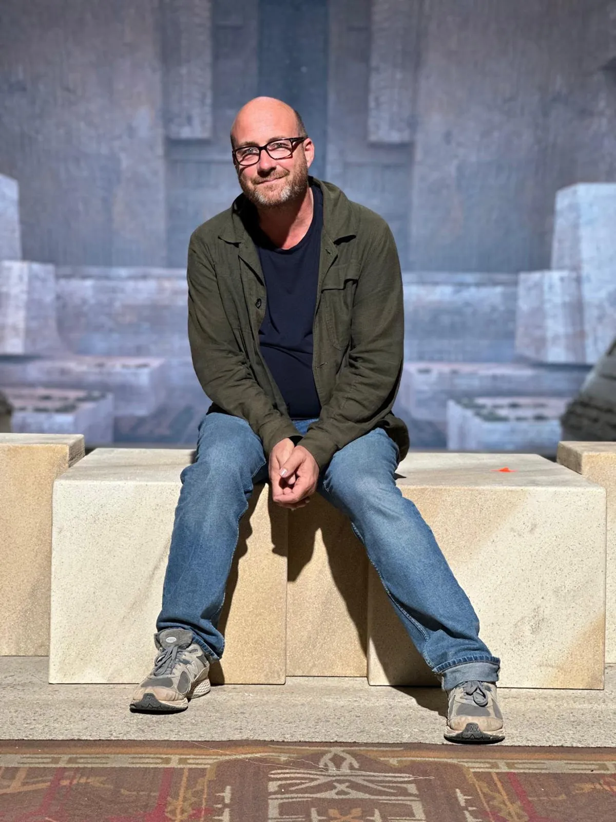 Production designer Patrice Vermette looking at a film set design model.