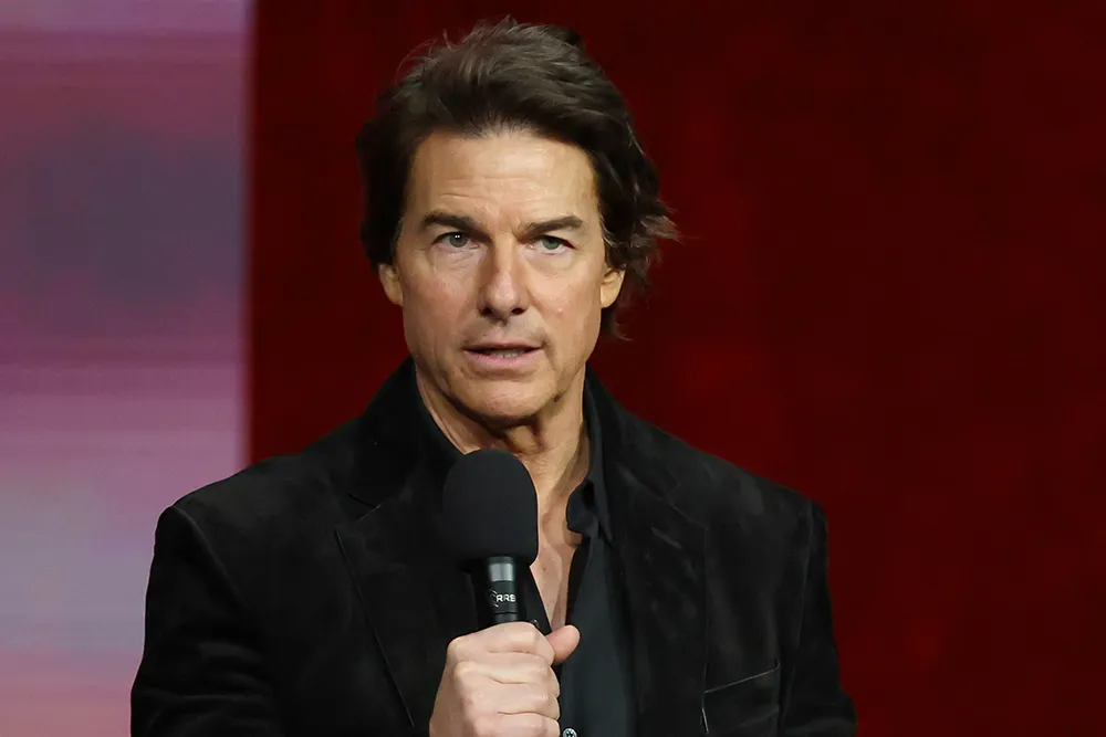 Tom Cruise speaking at a BAFTA 'Life in Pictures' event, looking thoughtful and engaged.