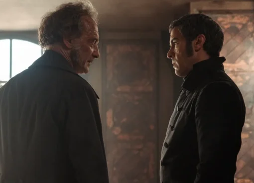 A dramatic still from the new French-language 'Les Misérables' film, featuring actors in historical costumes looking serious.
