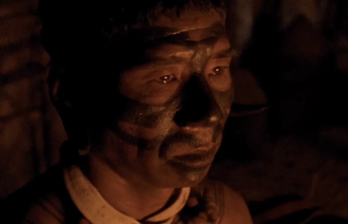 A visually striking scene from the film 'Angh', showing characters in a lush, natural setting of Nagaland.