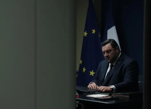 French President Paul Archambault, played by Denis Menochet, looking serious in a tense scene from the movie 'Jupiter'.