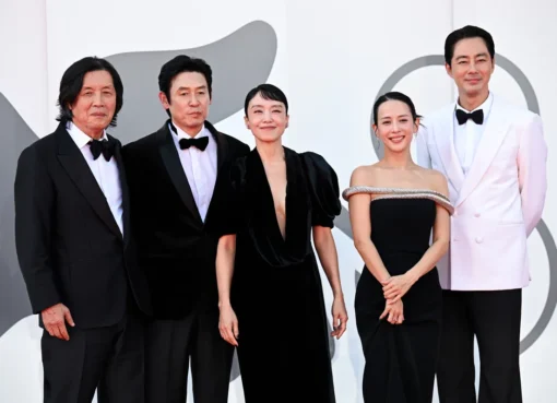 Director Lee Chang-dong and cast members embracing emotionally at the Venice Film Festival.