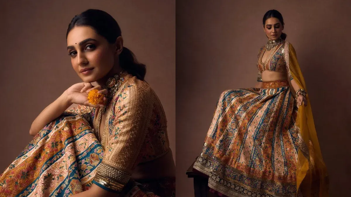 Vedika Pinto smiling, wearing a stunning colorful vintage lehenga at a festive event.
