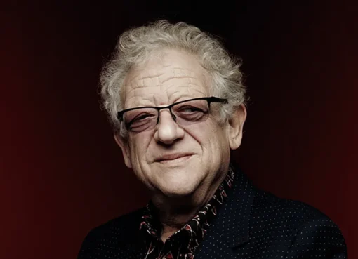 Portrait of British film producer Jeremy Thomas smiling gently.