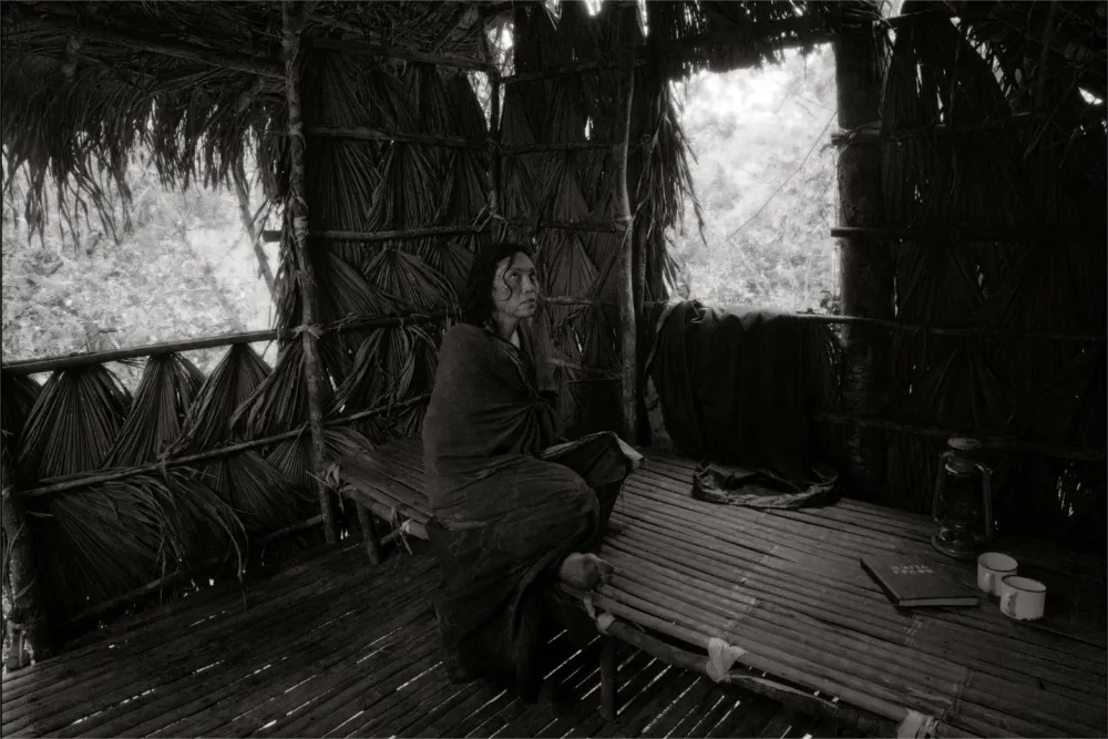 A black and white photo of filmmaker Lav Diaz, looking thoughtfully towards the side.