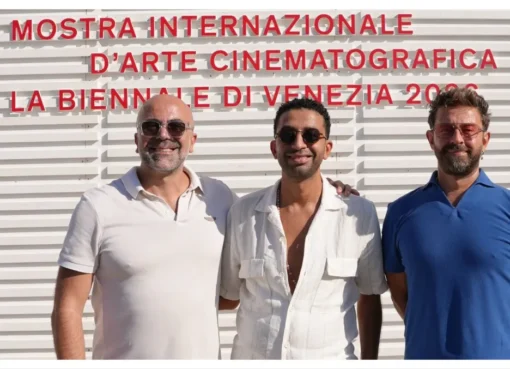 A photo of people shaking hands at the Venice Film Festival, symbolizing a new content partnership.