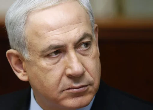 Israeli Prime Minister Benjamin Netanyahu speaks at a podium.