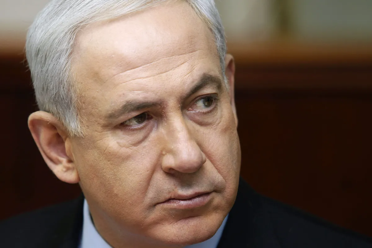 Israeli Prime Minister Benjamin Netanyahu speaks at a podium.