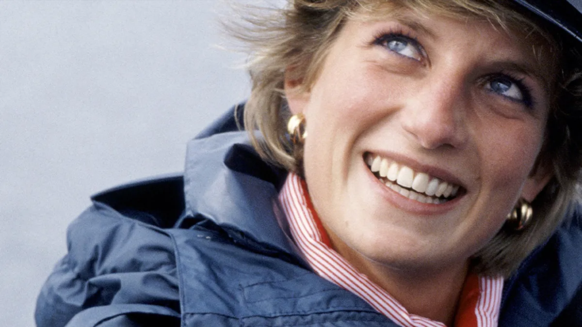 Princess Diana smiling and looking thoughtful.