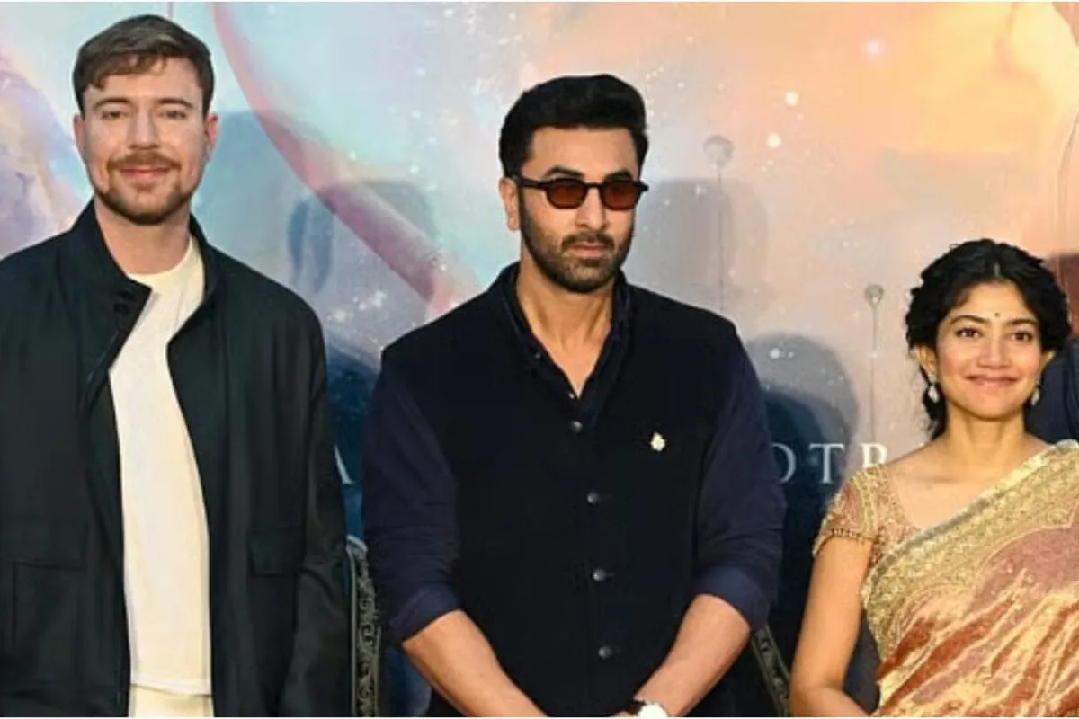 Ranbir Kapoor smiling next to MrBeast, who looks a bit puzzled, at a formal event.
