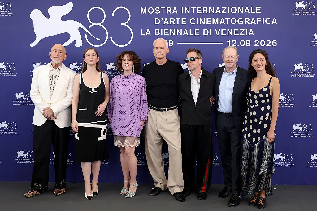 John Malkovich and Martin McDonagh smiling at the Venice Film Festival press conference.
