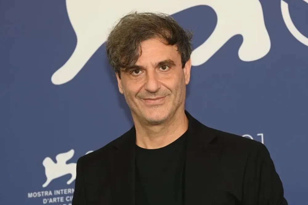 A serious-looking man, likely Alexandros Avranas, directing a film scene.
