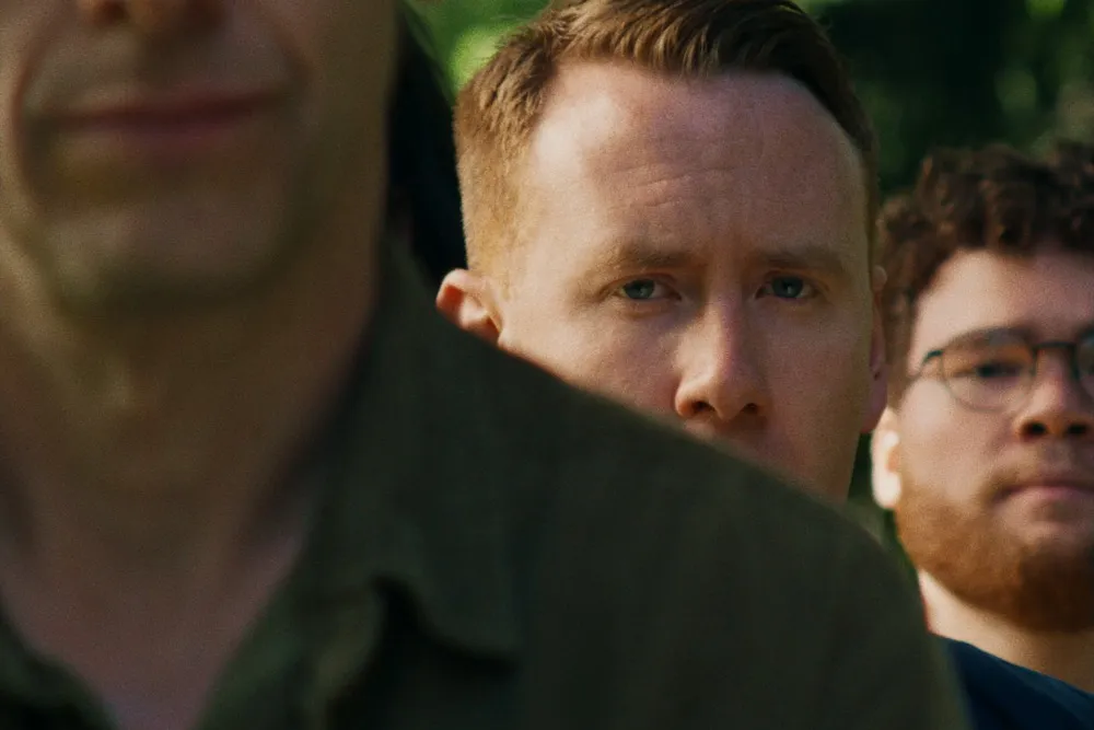 A young man, Danny Carlton, looking unsure and hesitant, portraying an aspiring life coach.
