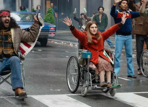 Judy Heumann in her wheelchair on a New York sidewalk, unable to climb a curb.