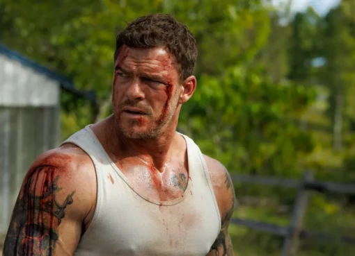 Director Scott Waugh on a movie set, discussing an action sequence with Alan Ritchson.