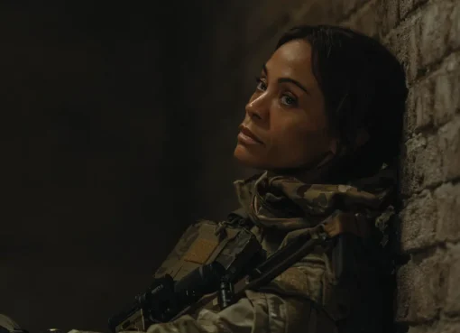 Zoe Saldaña smiling in a casual setting.