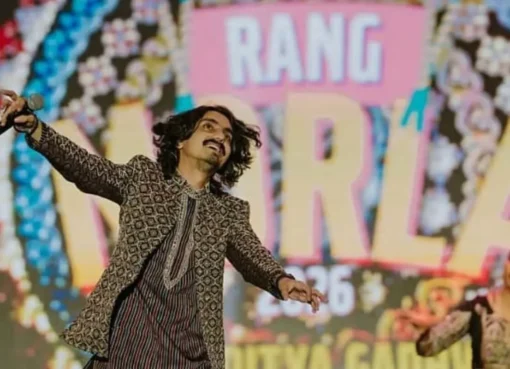Photo of Gujarati folk singer Aditya Gadhvi with a microphone.
