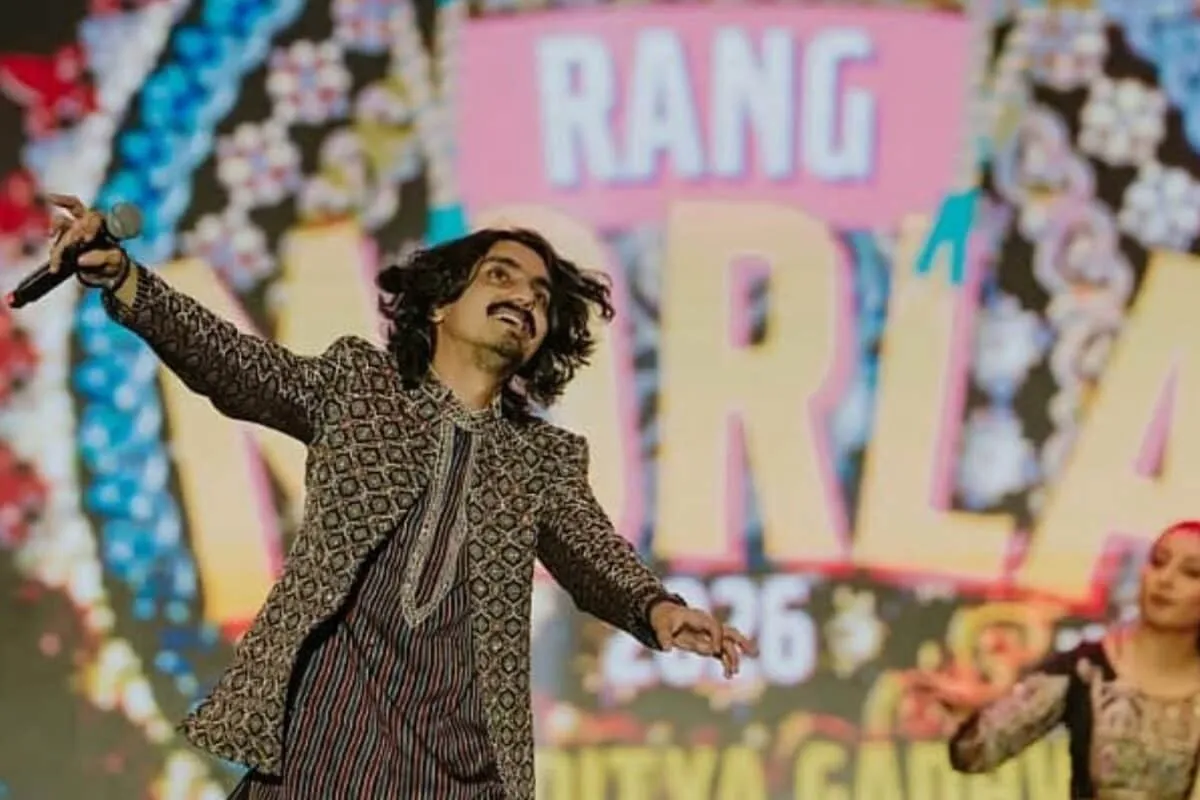 Photo of Gujarati folk singer Aditya Gadhvi with a microphone.
