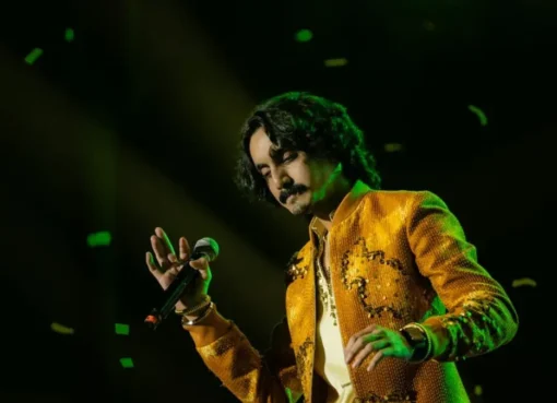Aditya Gadhvi performing on stage at a vibrant event