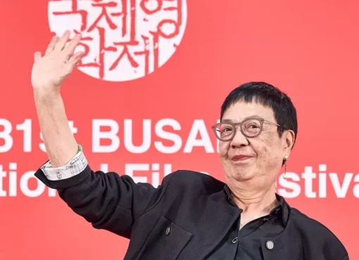Ann Hui smiling at the Busan International Film Festival, holding her Camellia Award.