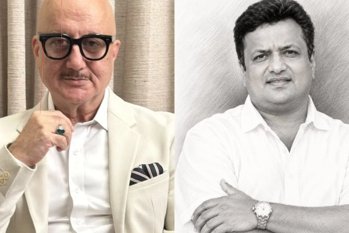 Anupam Kher and filmmaker Sanjay Gupta smiling warmly together.