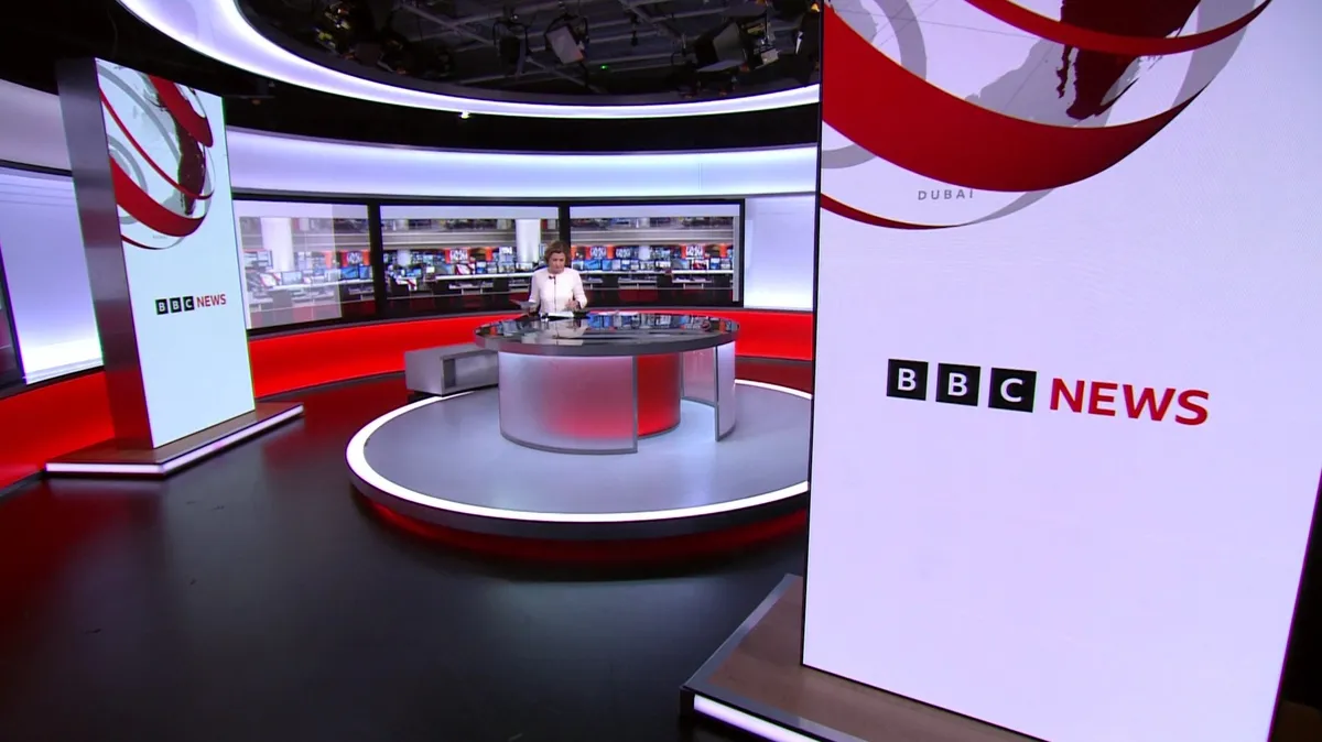 Four silhouettes standing in front of a BBC news logo, symbolizing the final candidates for the news chief role.