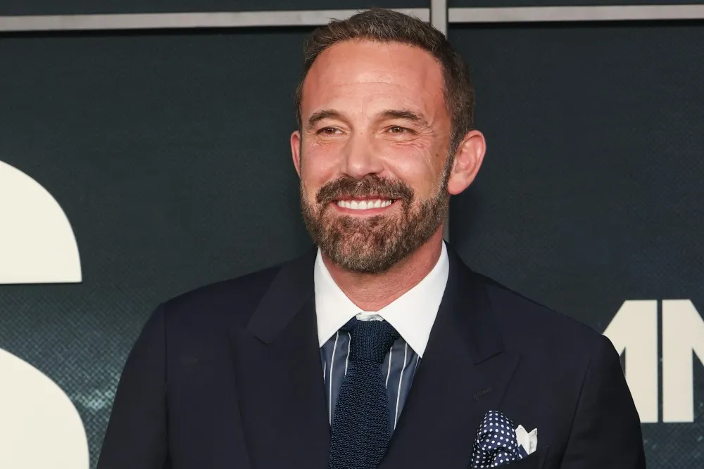 Ben Affleck looking serious in a suit, possibly from his new movie 'Animals'.