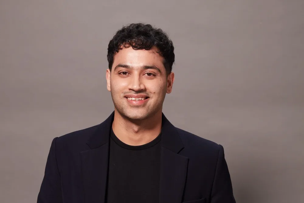 Raj Shamani smiling during a podcast recording