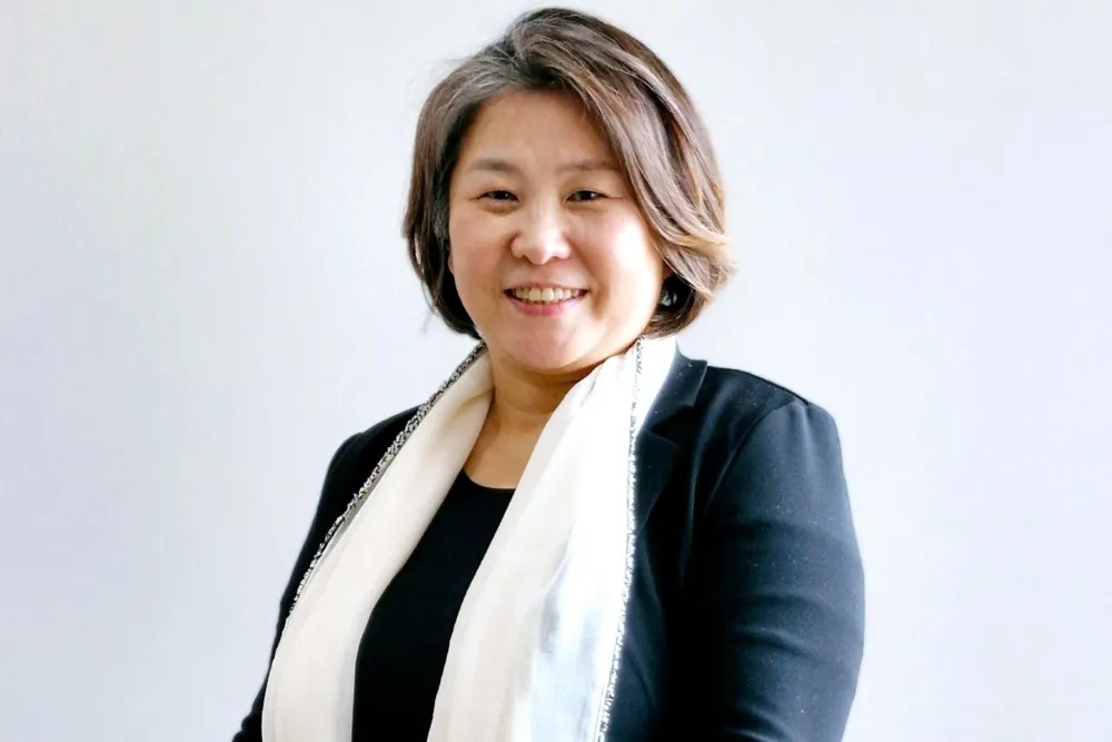 Portrait of Ellen Y.D. Kim smiling and looking thoughtful.