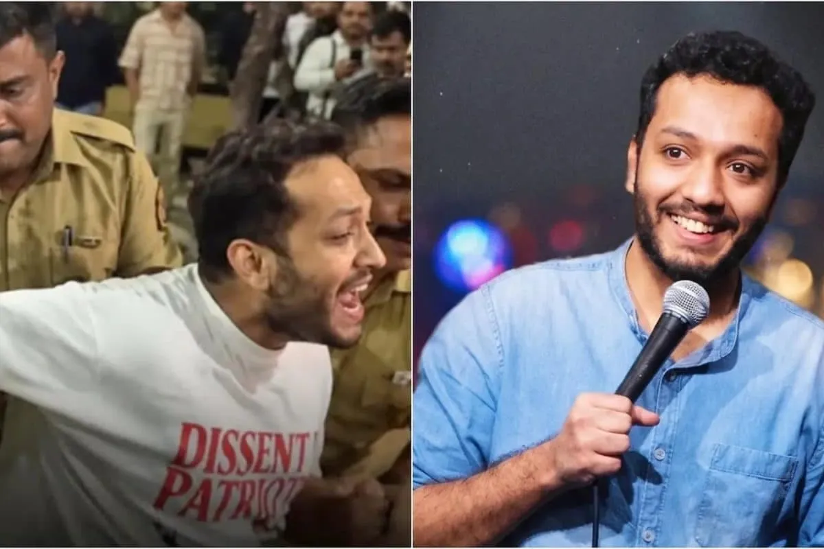 A distressed comedian being held by police during a protest.