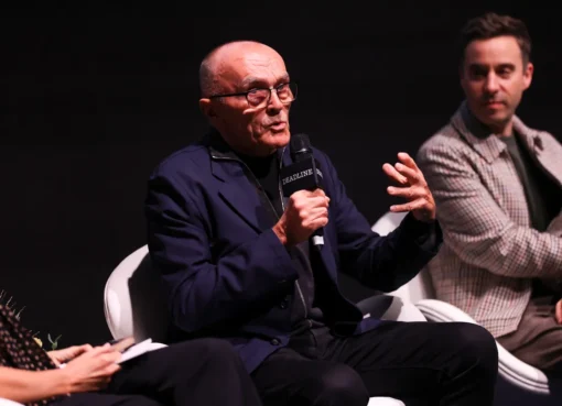Danny Boyle speaking on a stage at an event.