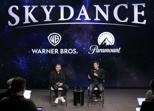 David Ellison and Ynon Kreiz at a press conference, both wearing jeans.