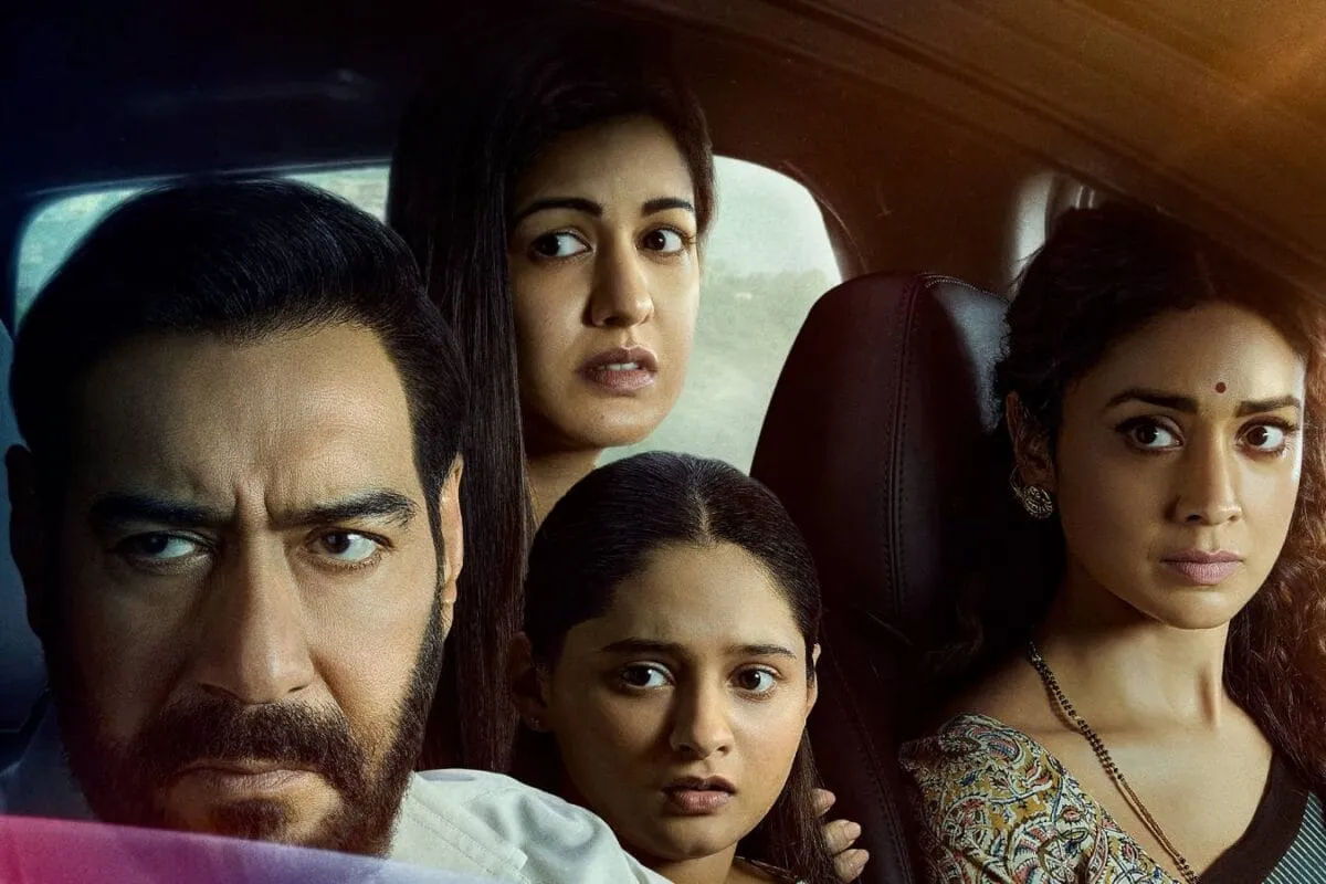 A movie poster for Drishyam 2 featuring Ajay Devgn and Tabu.