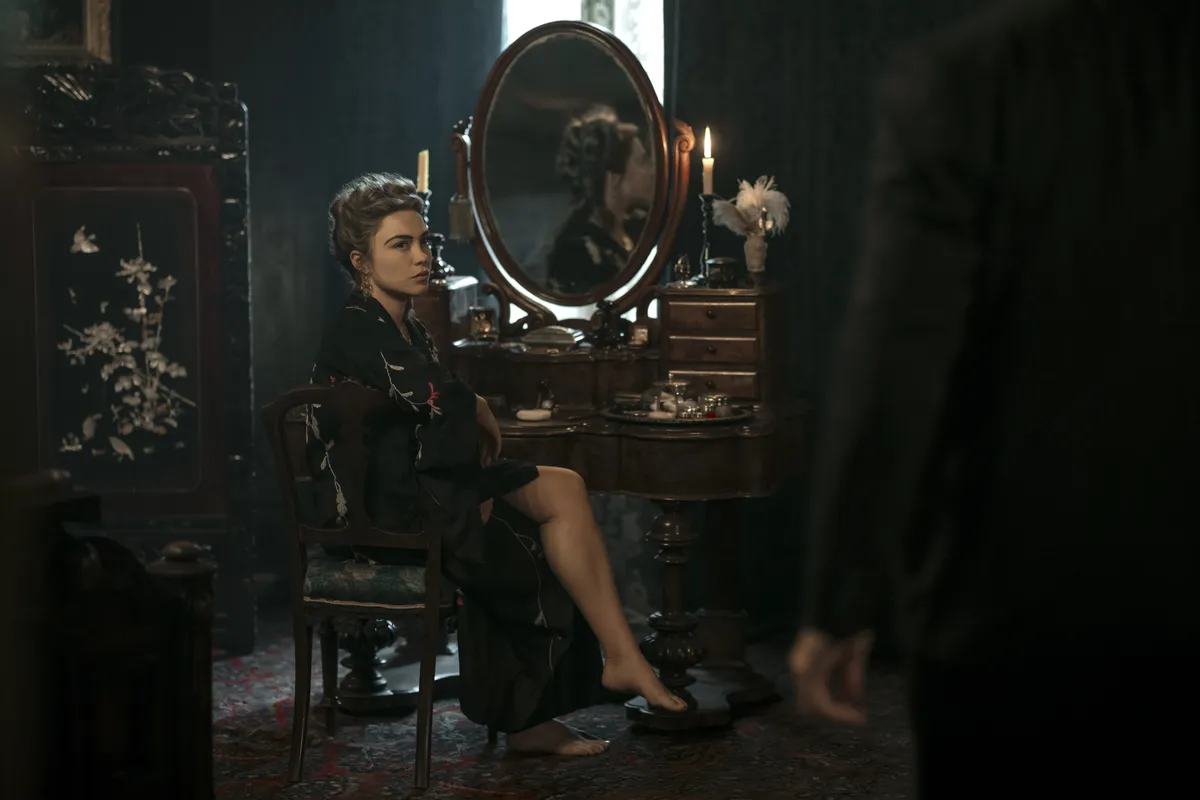Florence Pugh in a period costume looking intense.