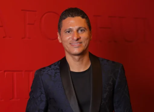 Amr Mansi smiling and speaking at the El Gouna Film Festival.