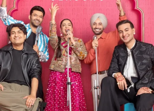 Kapil Sharma on stage with Jasmine Sandlas and Satinder Sartaaj, laughing and enjoying the show.