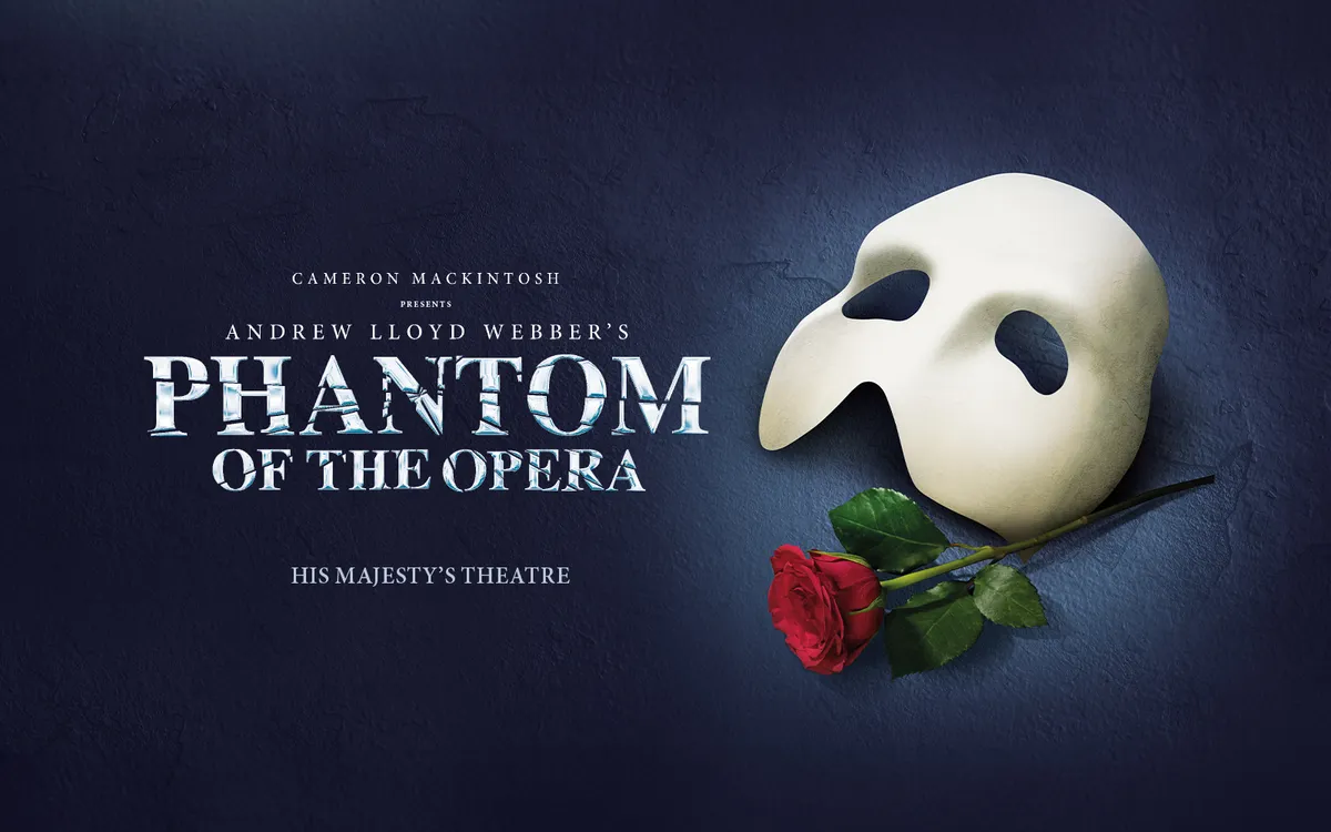 A masked Phantom in a dramatic, dimly lit scene, with a candelabra in the foreground.