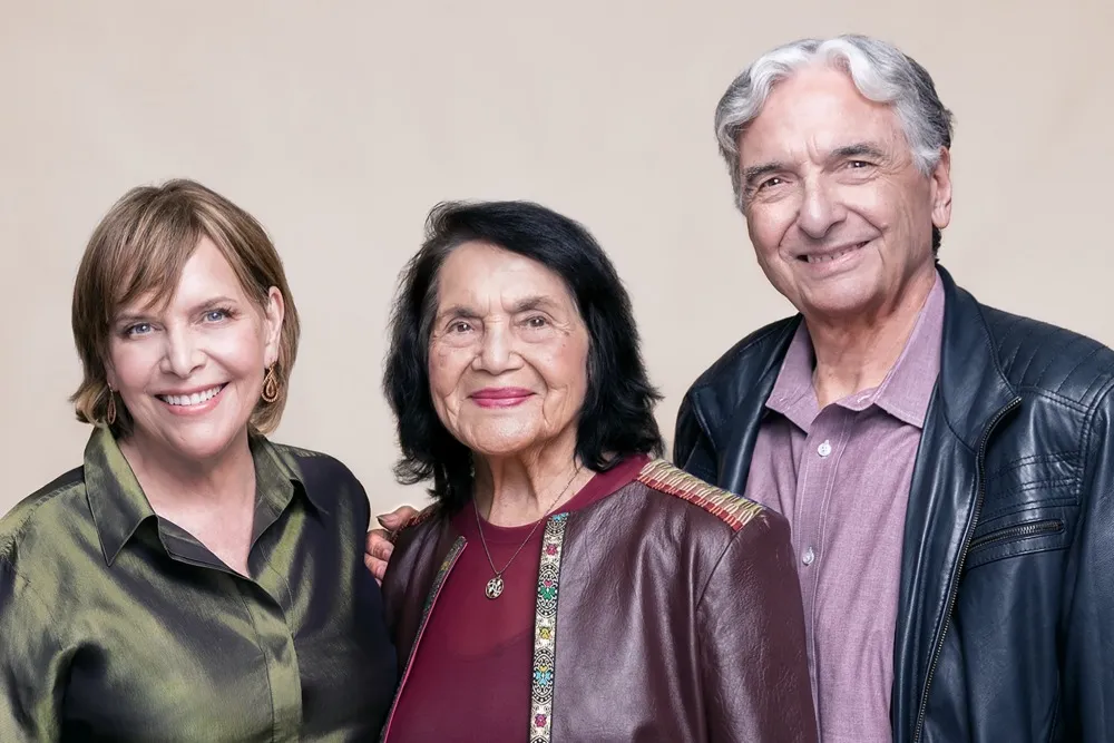 Director Gregory Nava smiling with civil rights icon Dolores Huerta.
