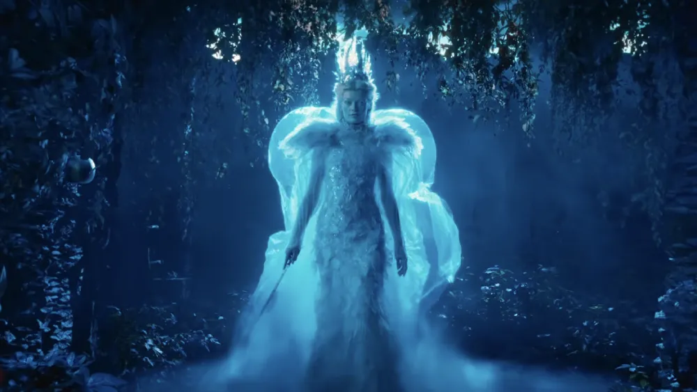 A magical forest scene from the 'Narnia: The Magician's Nephew' trailer, with shimmering trees and a path leading into light.