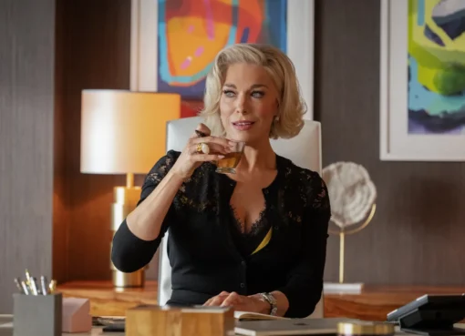 Hannah Waddingham smiling in a sharp suit as Rebecca Welton