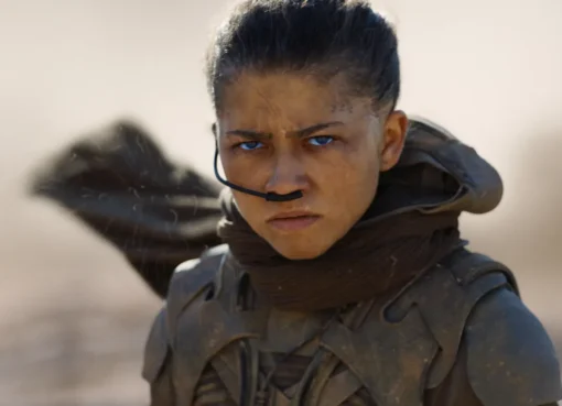 Zendaya as Chani in Dune, looking determined in desert attire.