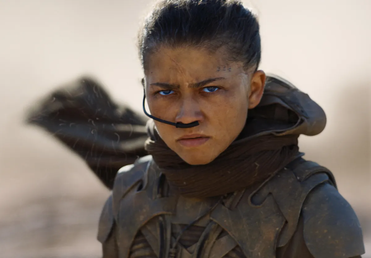Zendaya as Chani in Dune, looking determined in desert attire.