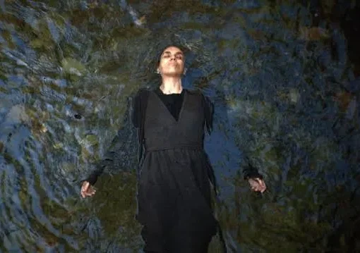 Promotional image for the horror film Motherwitch, featuring a mysterious, possibly cloaked figure.