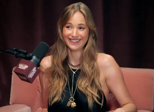 Jennifer Lawrence smiling at a red carpet event.